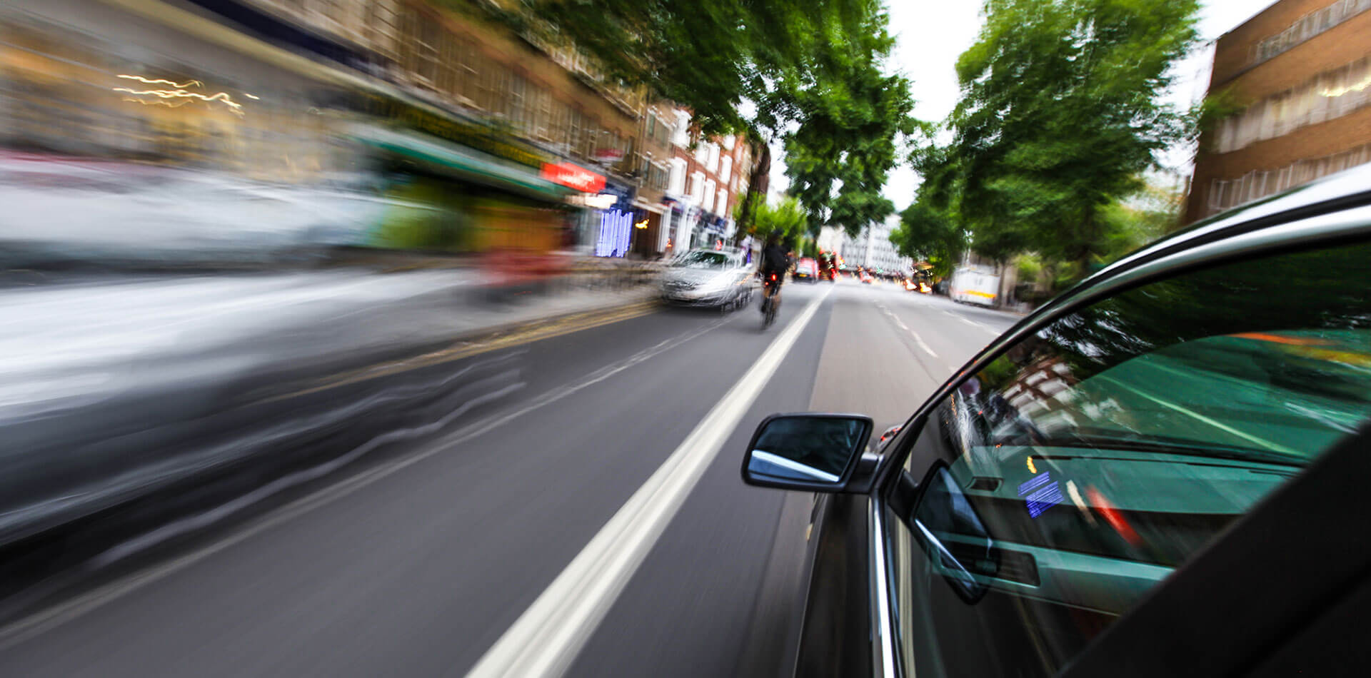 Car speeds past cyclist