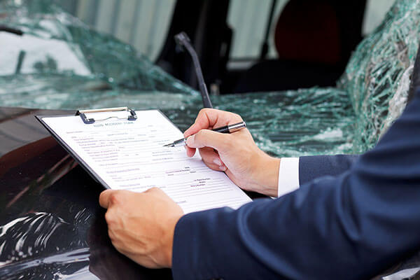 Investigator with check list at scene of RTA